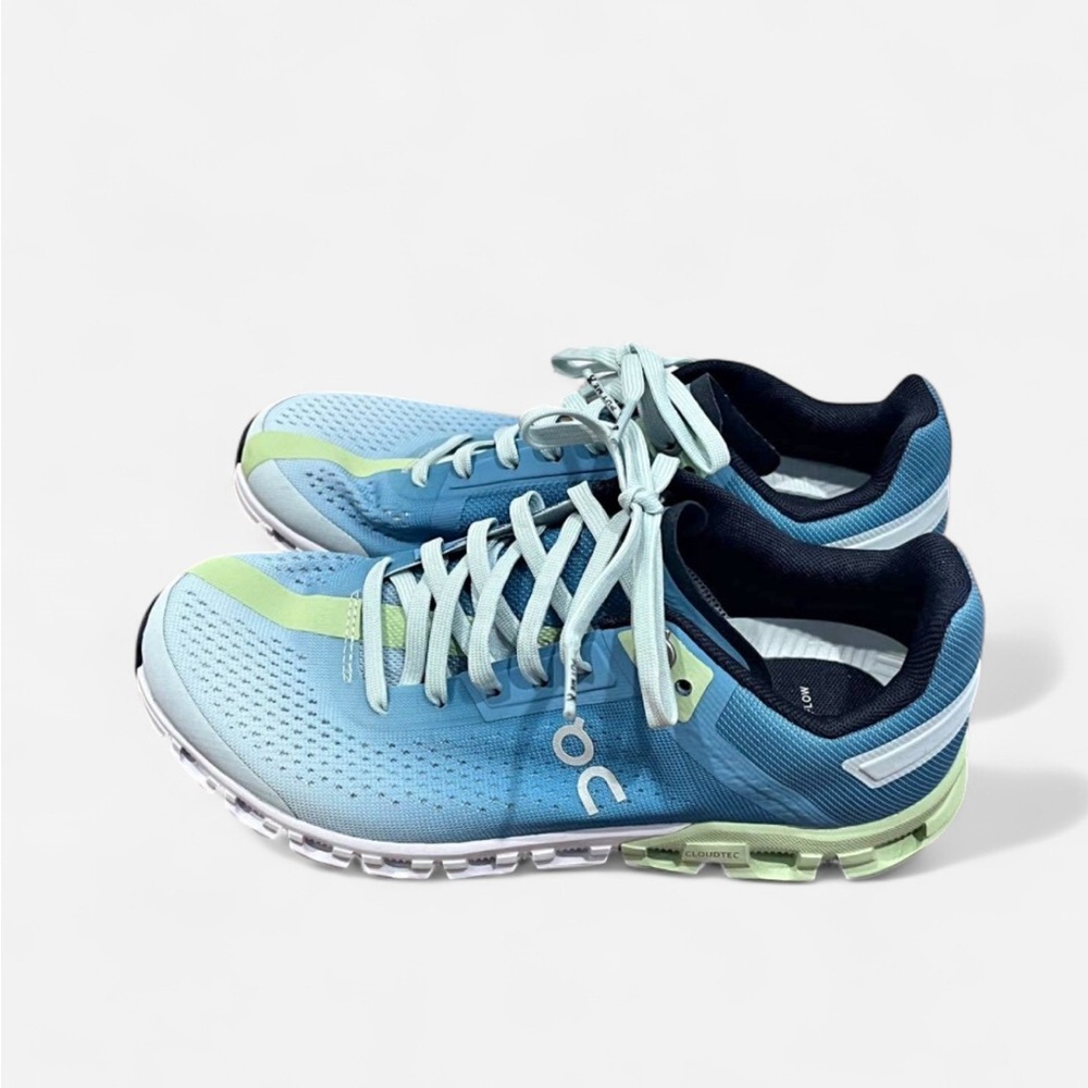 On Running Blue and Green Athletic Shoes with Cloud Cushioning